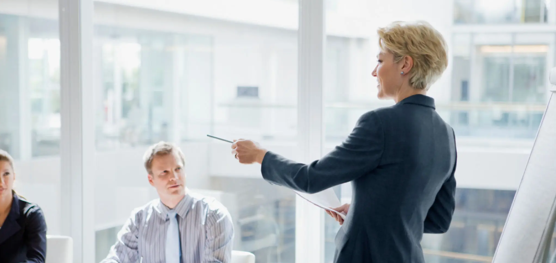 A businesswoman presenting ideas to colleagues in a meeting.